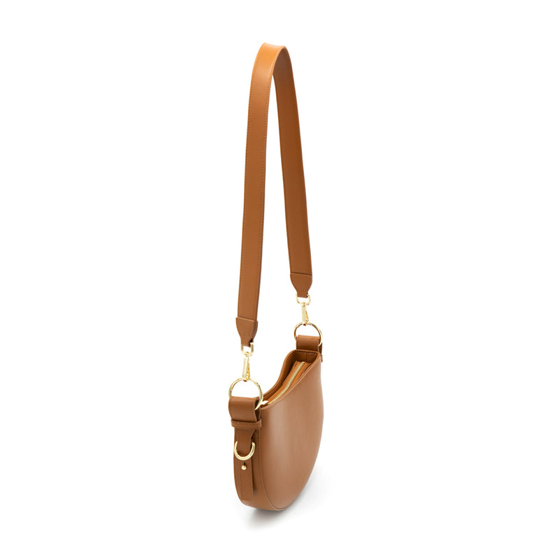 X NIHILO Lune modern saddle leather crossbody bag. Crafted from smooth calf leather and microfibre lining. Featuring a spacious single compartment, metal zip closure and wide shoulder strap offering extra comfort.