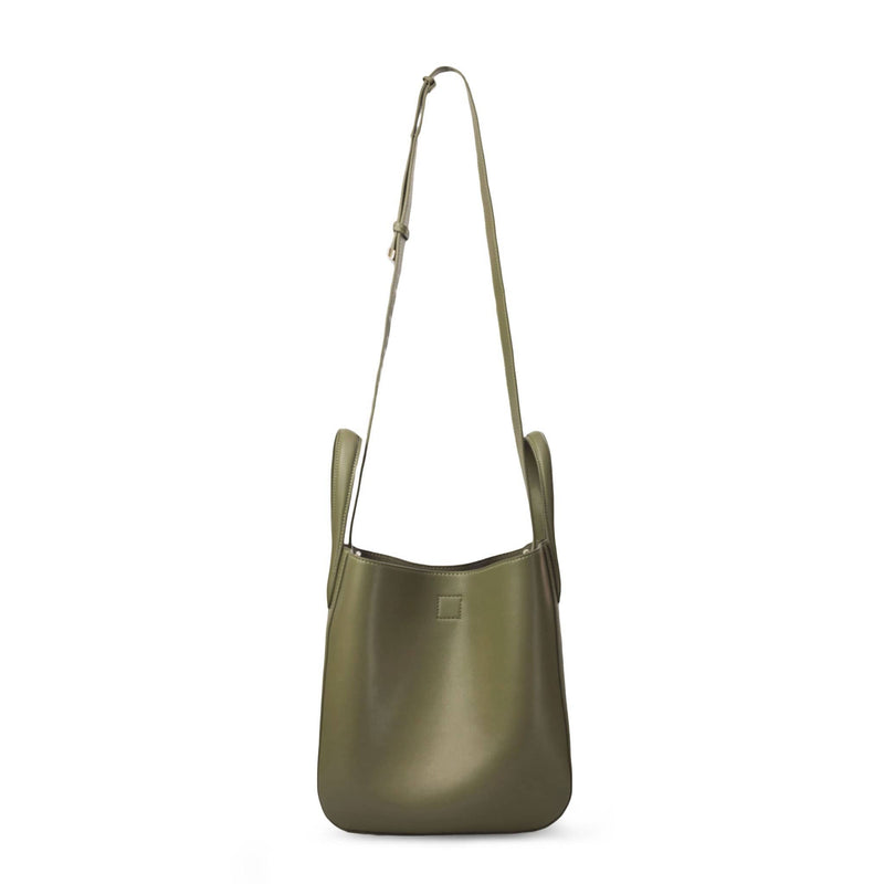 Side view of X NIHILO Eight mini in khaki bag, fashion bag with adjustable shoulder strap, single snap button top closure, and soft gold hardware, luxury cow nappa leather handbag, genuine leather bag, shoulder strap shown at full length.