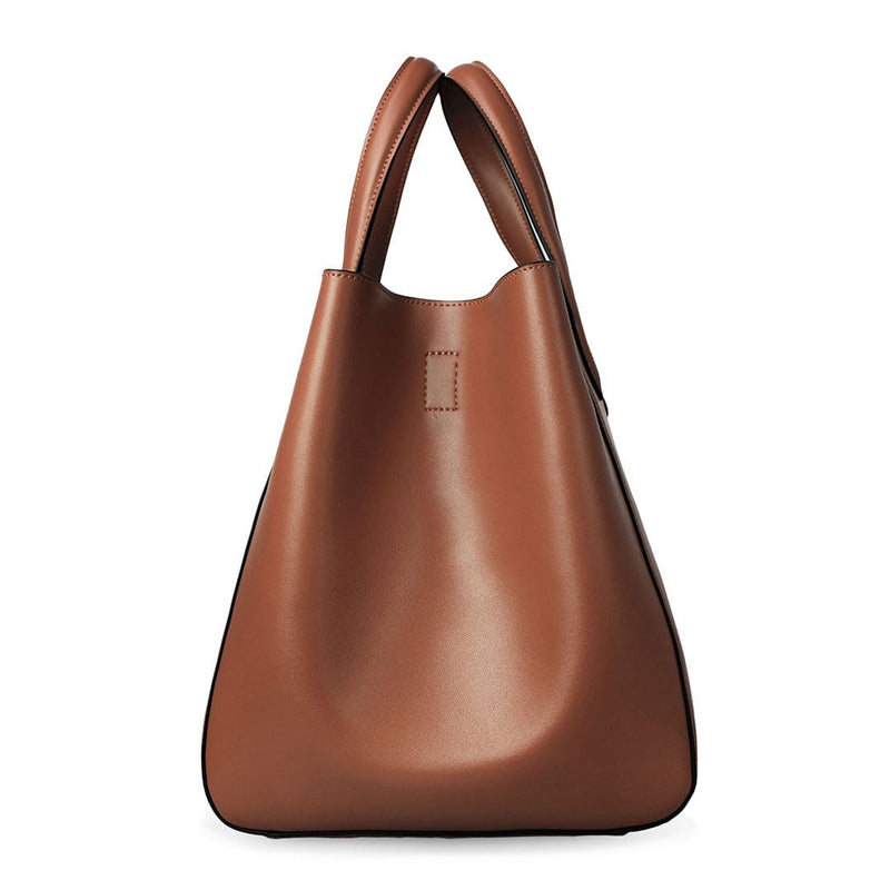 Side view of large tan genuine leather tote bucket bag, genuine nappa leather bag with handle and single button closure.