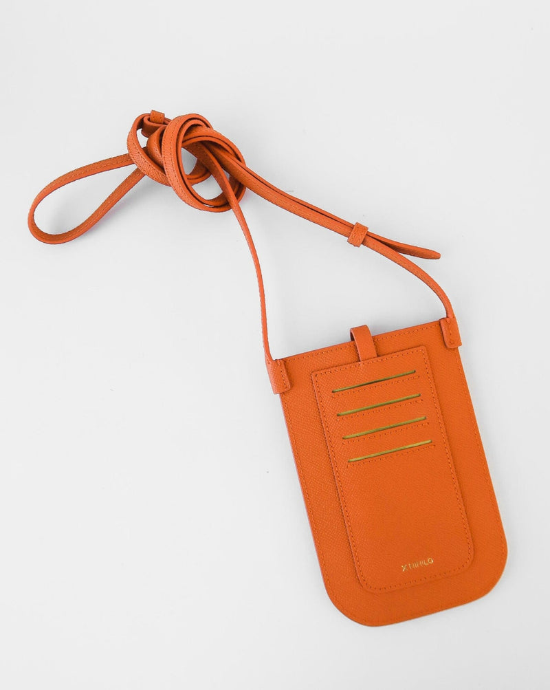 Rectangular Tangerine orange phone pouch with opening on top and an attached shoulder strap. Back view of the 4 card slots and logo against white background.