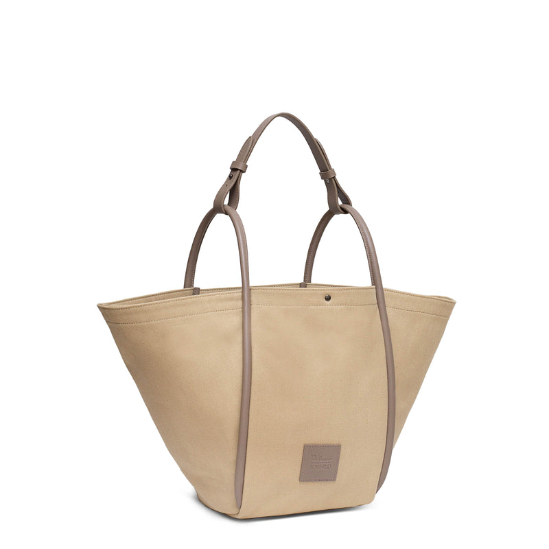 Camel canvas tote bucket bag, with camel rolled leather handles, silver button closure at the top and small square logo of WEST14TH and X NIHILO.
