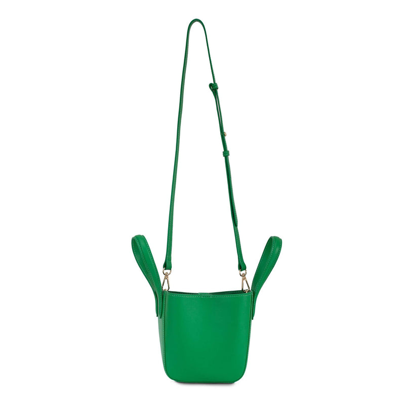 Side angle of micro bright green leather bucket hybrid handbag, with top handle and strap at full length.