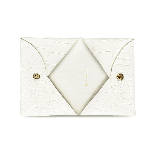 View of opened white croc print leather cardholder with gold snap closure, logo X NIHILO embossed in gold inside.