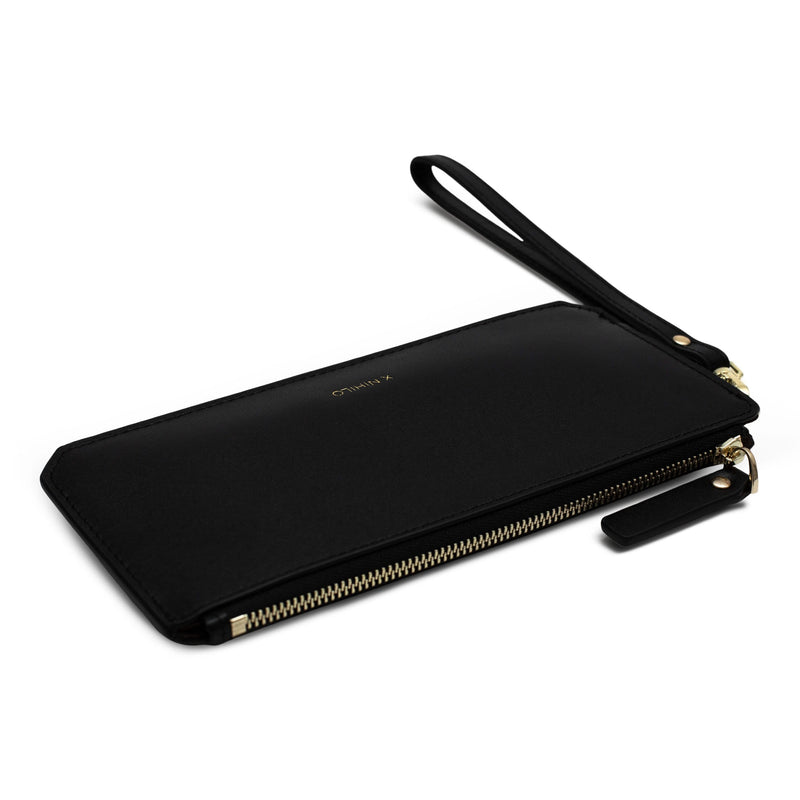 Slim black genuine cow nappa leather wallet with leather strap and logo X NIHILO embossed in gold in the bottom centre, the wallet is flat on its back.