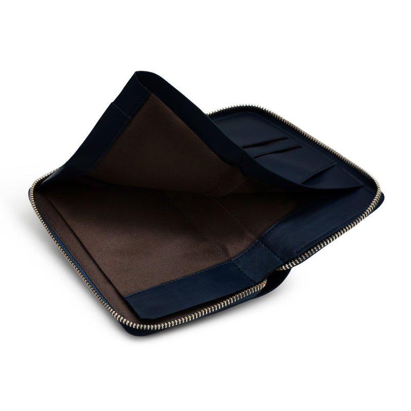View of opened navy genuine cow nappa leather wallet and passport holder with its inner sleeve lifted up.