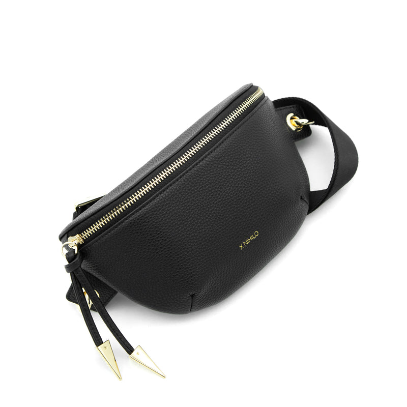 X NIHILO City urban everyday leather bumbag sling bag. Presents a spacious compartment closed securely with a metal zip and finished with a leather and feature hardware, removable and adjustable shoulder strap.
