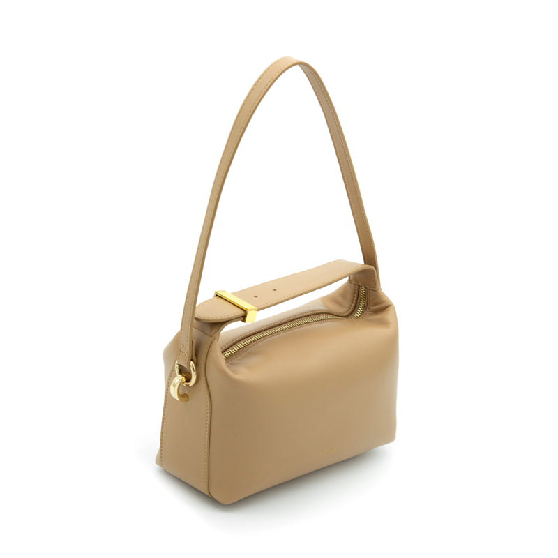 X NIHILO Pillow top handle leather crossbody bag. Crafted in soft calf leather presents a top handle and clasp, with detachable shoulder strap - a classic for any occasion.