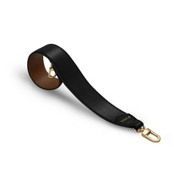 Black and tan genuine leather bag strap with gold hardware and X NIHILO logo embossed in gold near clasp.