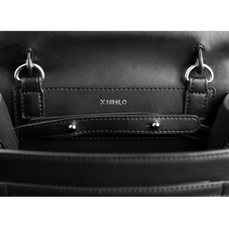Detailed close up shot of black genuine cow nappa leather bag inner  with silver hardware details and X NIHILO logo embossed in silver in the centre.