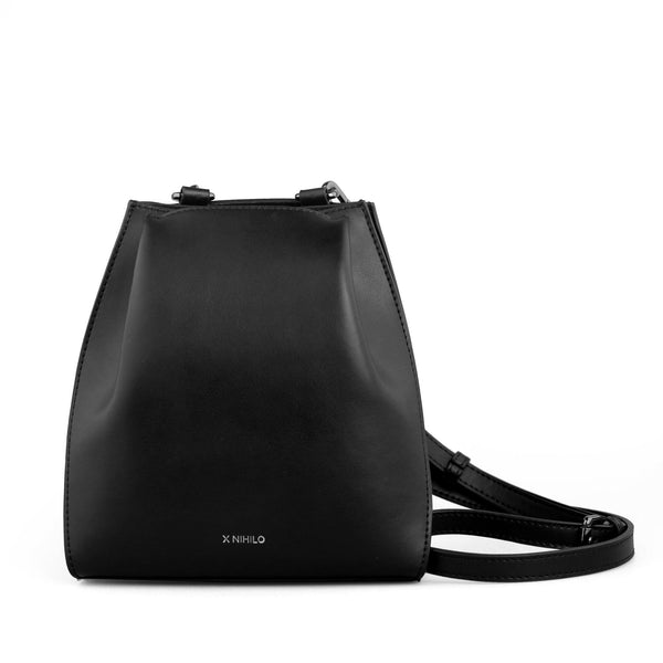 Hybrid mini bucket bag in black and white nappa leather, with gunmetal hardware, detachable and adjustable strap, two press-stud on sides of the top opening.
