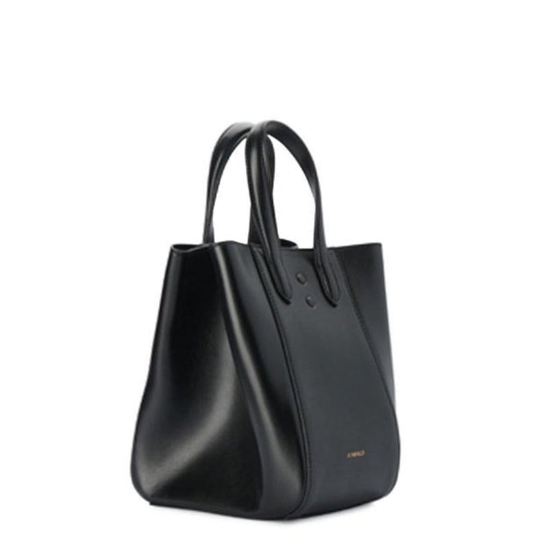 Angled side view of mini luxury black leather tote bucket bag, genuine nappa leather bag with handle and logo X NIIHILO embossed in gold on the bottom front, single button closure.