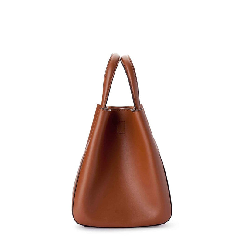 Side view of mini tan leather tote bucket bag, genuine nappa leather bag with handle and logo X NIIHILO embossed in gold on the bottom front.