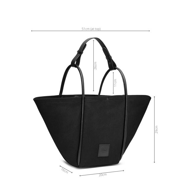 Measurement of black hardwearing canvas bag leather with rolled leather handles. Height 29cm, depth 16cm, width (at top) 51cm, width (at base) 20cm, handle drop 11cm.