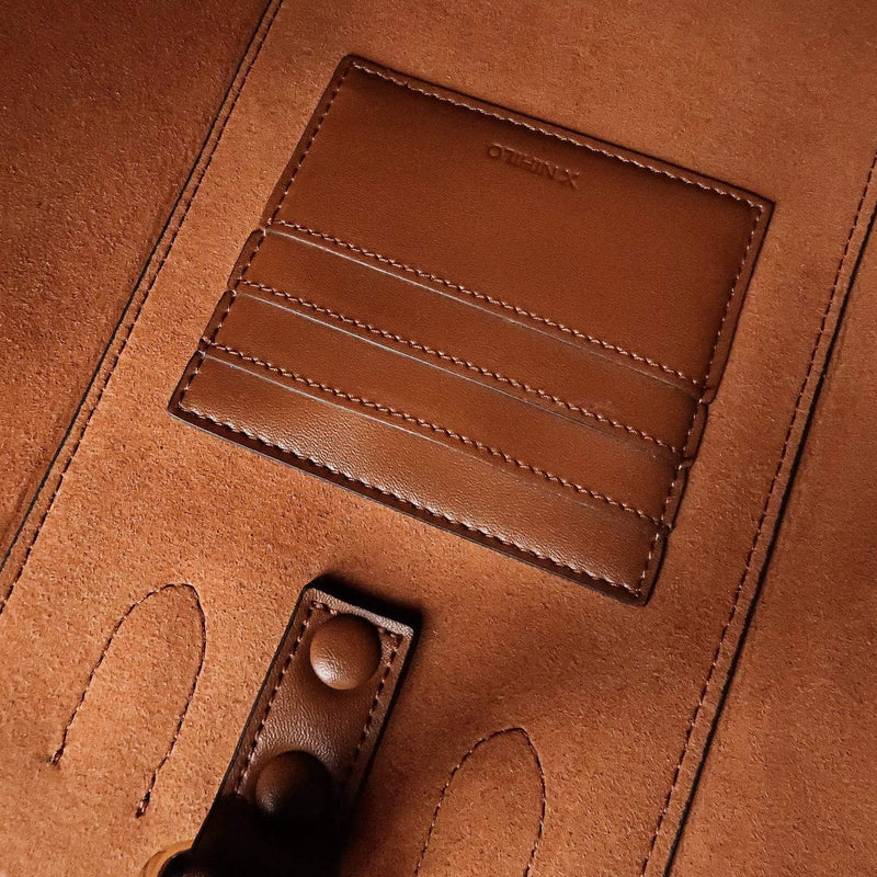 Inside of tan nappa leather bag, card slots and button detailing