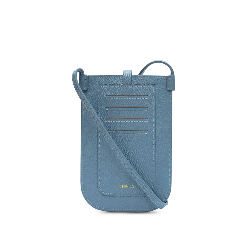 Rectangular Chambray blue phone pouch with opening on top and  attached shoulder strap. Back view, 4 card slots and logo.