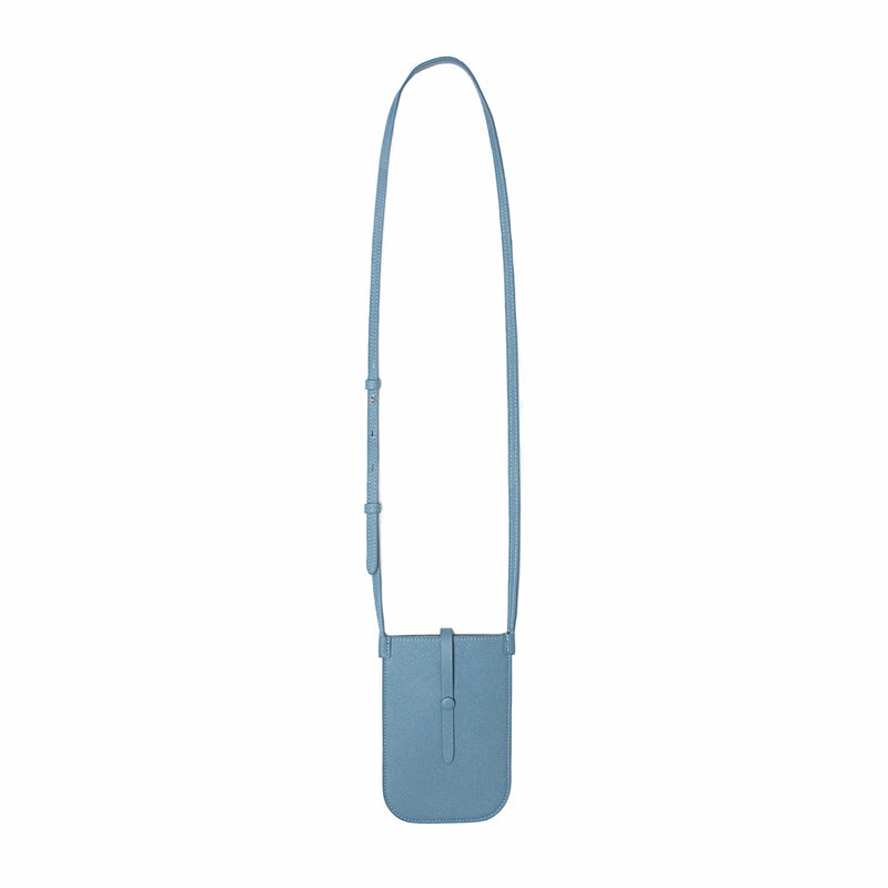 Rectangular Chambray blue phone pouch with opening on top and a attached shoulder strap fully extended