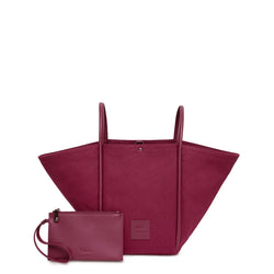 Burgundy canvas tote bucket bag, with burgundy rolled leather handles, silver button closure at the top and small square logo of WEST14TH and X NIHILO. Small burgundy leather pouch shown in front with hand strap.