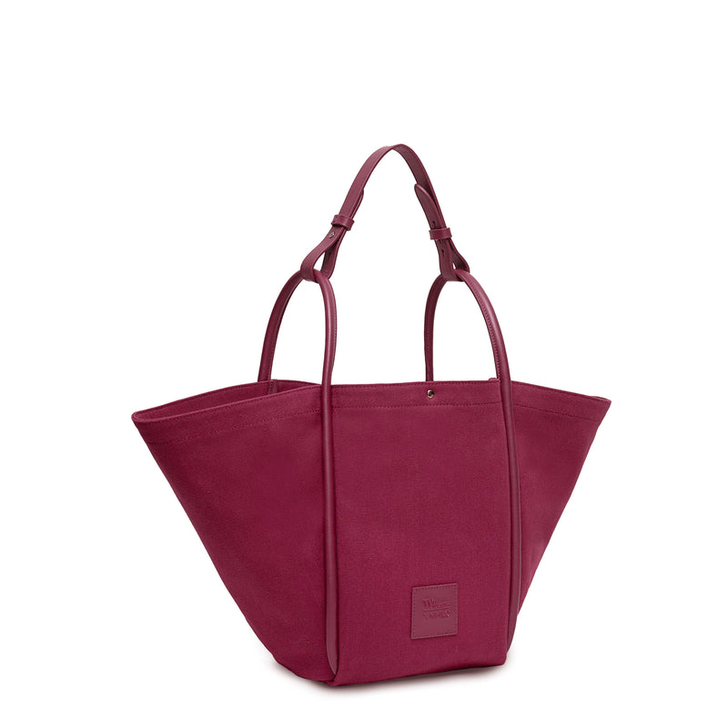 Burgundy canvas tote bucket bag, with burgundy rolled leather handles, silver button closure at the top and small square logo of WEST14TH and X NIHILO.