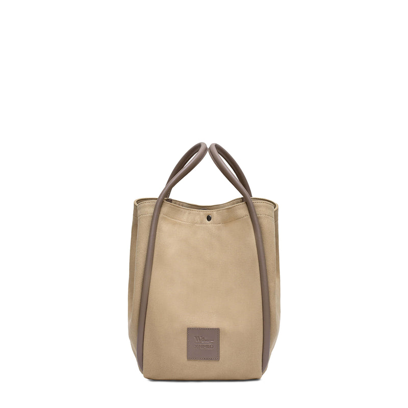 Camel canvas tote bucket bag, with ccamel rolled leather handles, silver button closure at the top and small square logo of WEST14TH and X NIHILO. Shown as bucket bag, with button used to bring in wings.