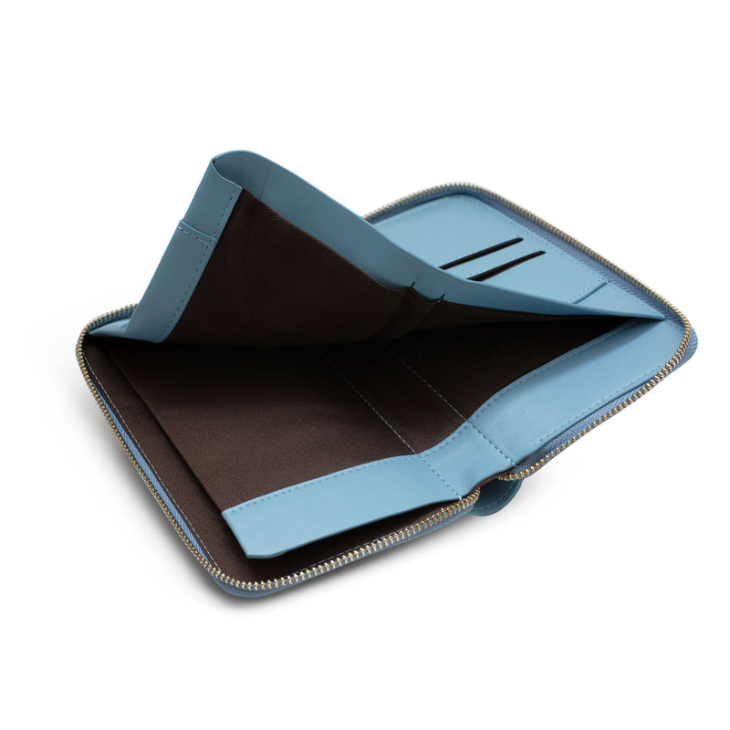 View of opened sky blue leather wallet and passport holder with its inner sleeve lifted up.
