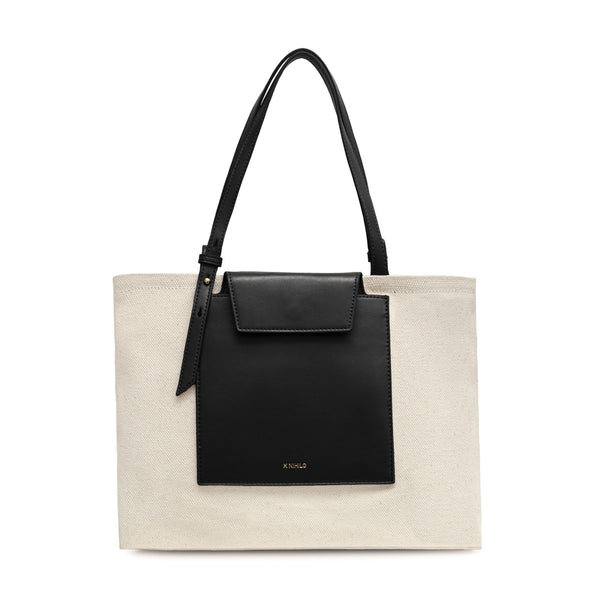 Rectangle black leather and natural canvas fabric tote bag with black leather handle, logo X NIHILO embossed small on the surface. 