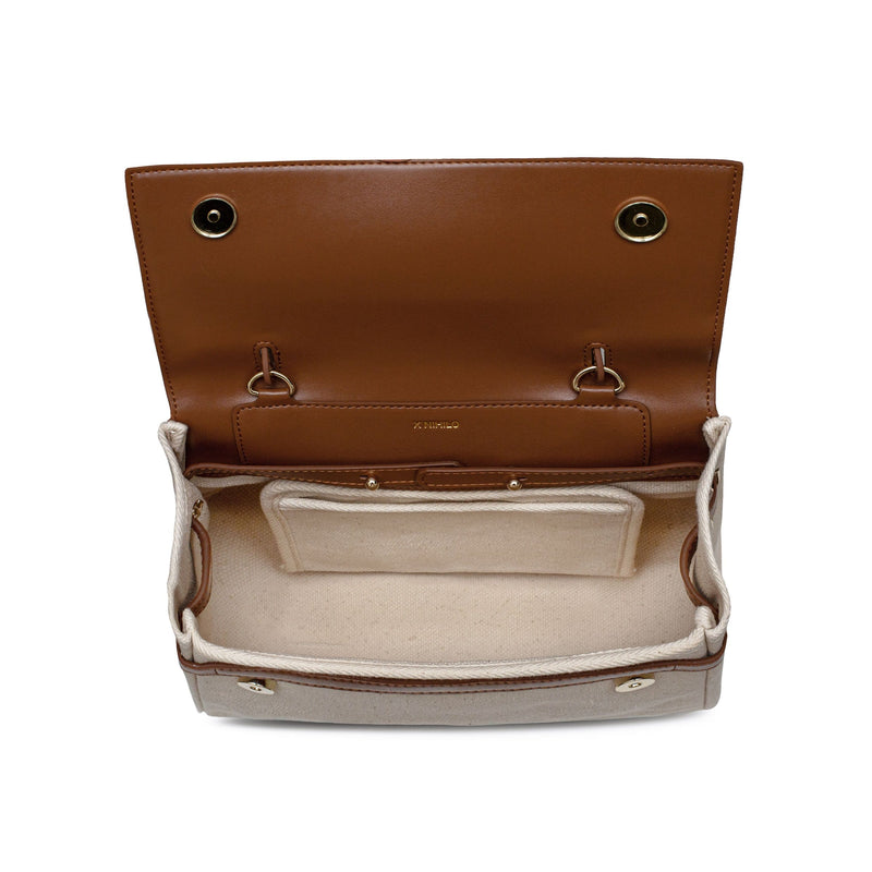 Top view of opened tan cow nappa leather and natural canvas fabric bag with metal hardware and X NIHILO logo detail on the inside, inside compartment detail.